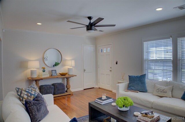 living room with crown molding, hardwood / wood-style floors, and ceiling fan