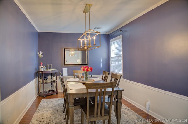 dining area featuring a notable chandelier, dark hardwood / wood-style flooring, and crown molding