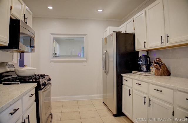 kitchen with white cabinets, light tile patterned floors, stainless steel appliances, and light stone countertops