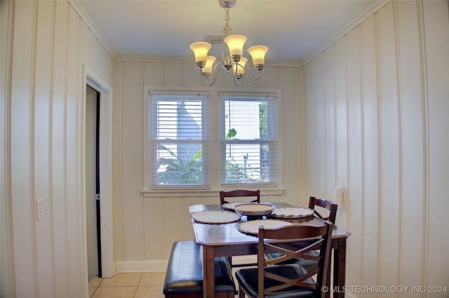 tiled dining room with crown molding and a notable chandelier