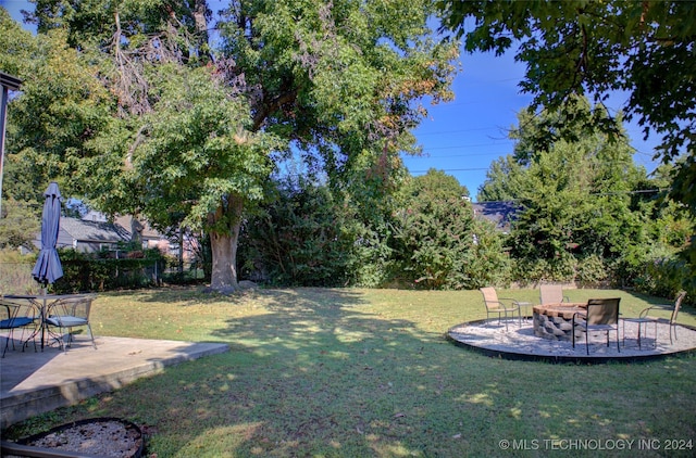 view of yard featuring a patio and a fire pit