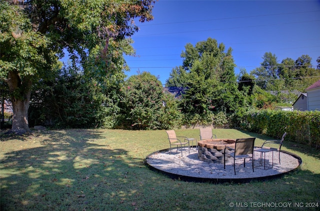 view of yard with an outdoor fire pit