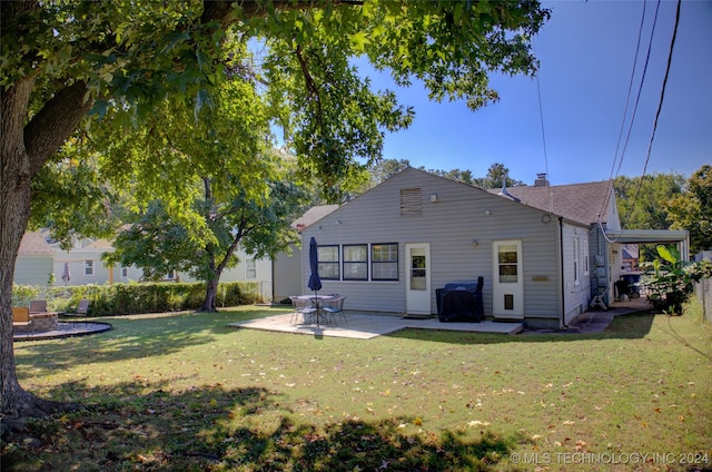 rear view of property with a patio area and a yard