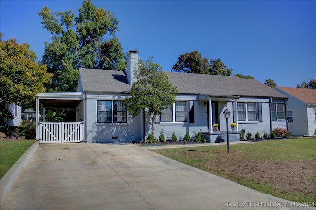 view of front of property with a front yard and a carport