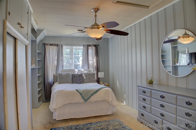 bedroom with carpet flooring, ceiling fan, and crown molding