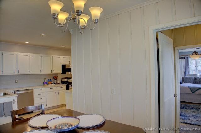 dining space with crown molding and a notable chandelier