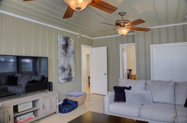 living room featuring ornamental molding and light tile patterned flooring