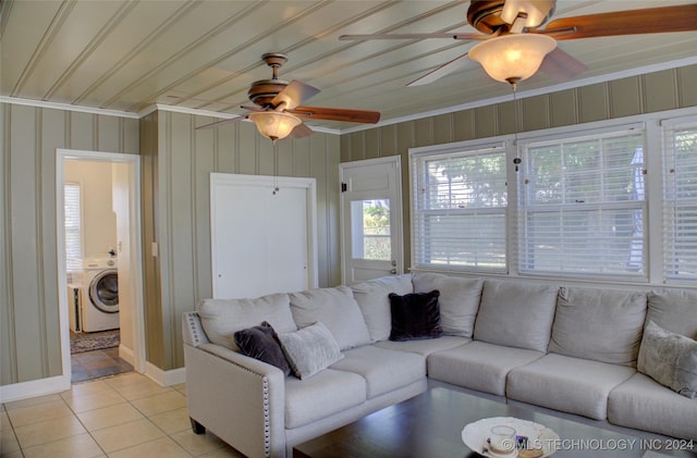 tiled living room with washer / clothes dryer and ornamental molding