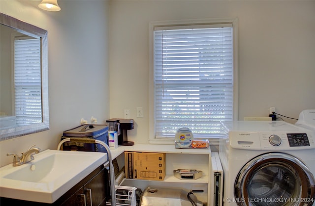 washroom with washer / clothes dryer and sink