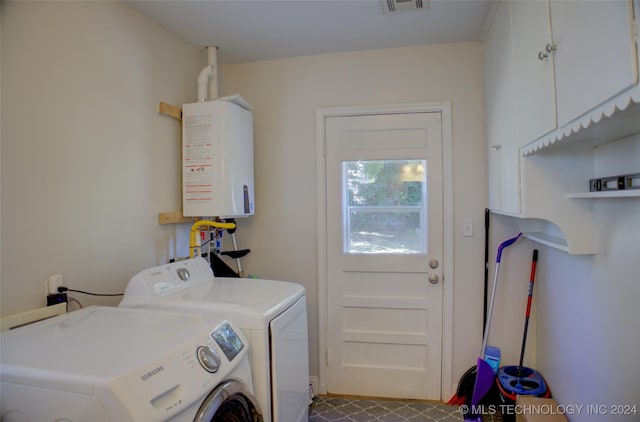 laundry area featuring water heater and washing machine and clothes dryer