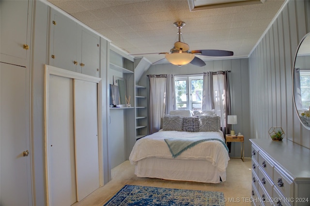 carpeted bedroom featuring ceiling fan and crown molding