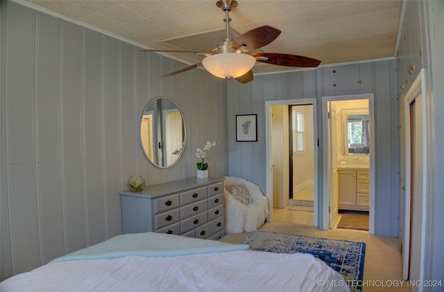 carpeted bedroom featuring ceiling fan, ornamental molding, and connected bathroom