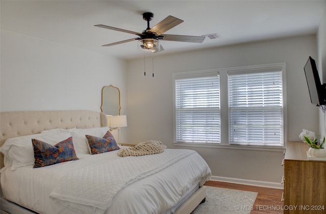 bedroom with hardwood / wood-style flooring and ceiling fan