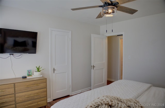 bedroom with ceiling fan and dark hardwood / wood-style flooring