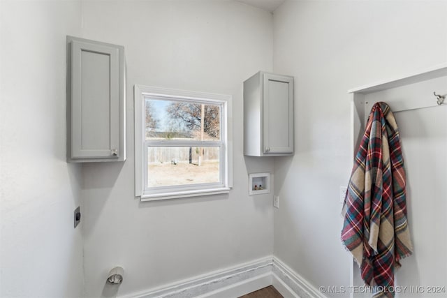 clothes washing area featuring cabinets, washer hookup, and electric dryer hookup