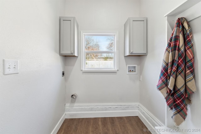 laundry area featuring electric dryer hookup, cabinets, washer hookup, and dark hardwood / wood-style floors