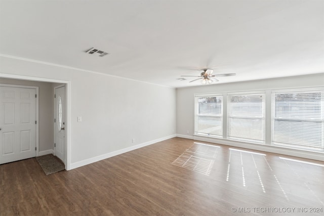 spare room featuring hardwood / wood-style flooring, ceiling fan, and ornamental molding