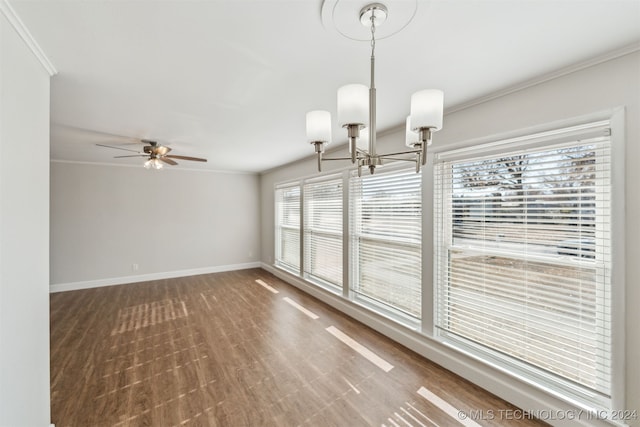 empty room with hardwood / wood-style floors, ceiling fan with notable chandelier, and ornamental molding