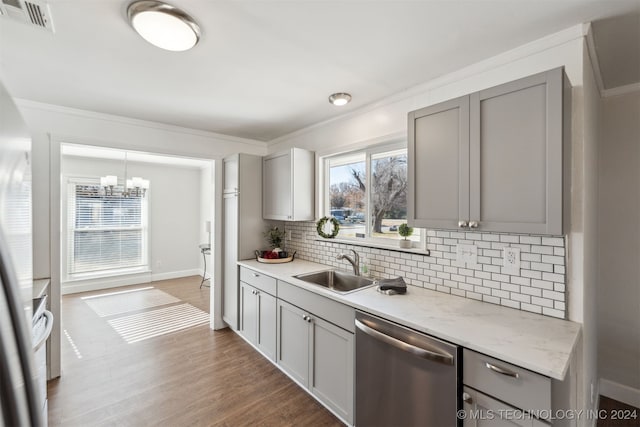 kitchen featuring gray cabinetry, stainless steel appliances, and wood-type flooring