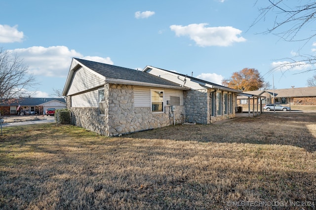 back of house with a lawn