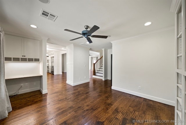 unfurnished living room featuring dark hardwood / wood-style floors, built in features, ceiling fan, and ornamental molding