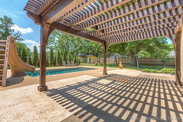 view of patio featuring a pergola, a playground, and a fenced in pool