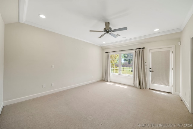 carpeted empty room featuring ceiling fan and crown molding