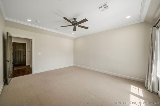 carpeted empty room with ceiling fan and ornamental molding