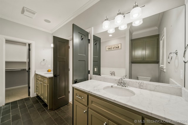 bathroom with tile patterned floors, crown molding, vanity, and toilet