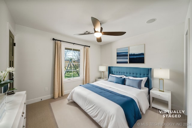 bedroom featuring ceiling fan and light carpet