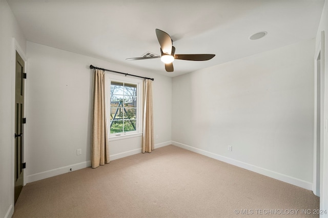 unfurnished room featuring light colored carpet and ceiling fan