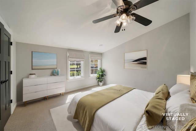 carpeted bedroom with ceiling fan and lofted ceiling