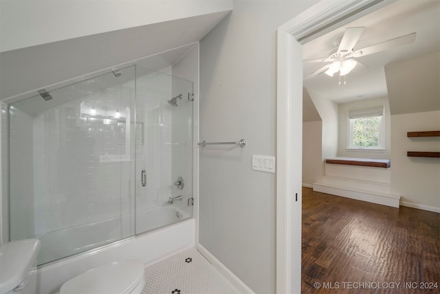 bathroom with hardwood / wood-style floors, ceiling fan, toilet, and shower / bath combination with glass door