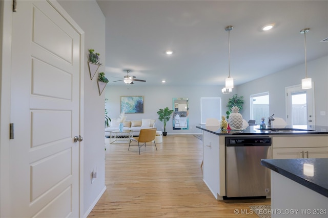 kitchen with dishwasher, white cabinetry, sink, and hanging light fixtures