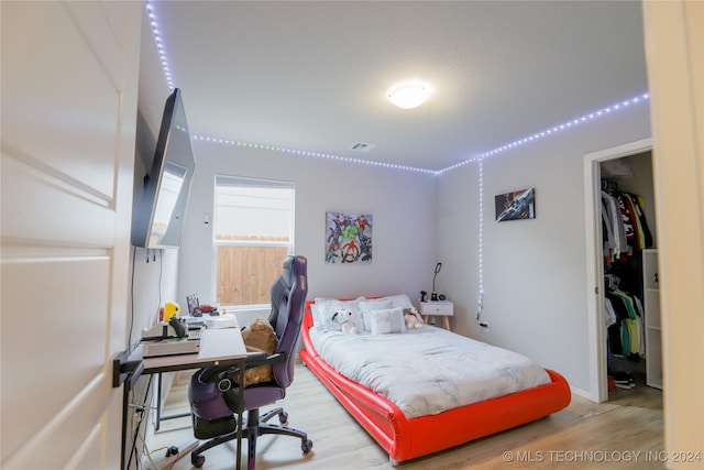 bedroom featuring hardwood / wood-style flooring and a closet