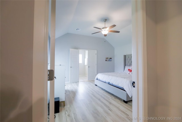 bedroom featuring ceiling fan, lofted ceiling, and light hardwood / wood-style flooring