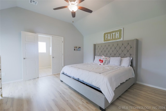 bedroom with ceiling fan, light hardwood / wood-style flooring, and vaulted ceiling