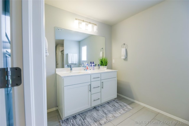 bathroom featuring tile patterned flooring, vanity, and an enclosed shower