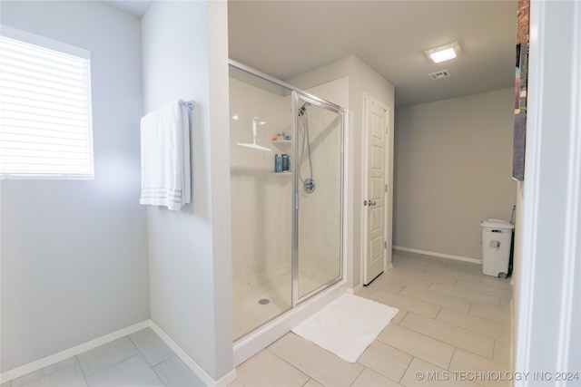 bathroom with tile patterned floors and a shower with shower door