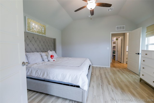 bedroom featuring ceiling fan, lofted ceiling, and light wood-type flooring