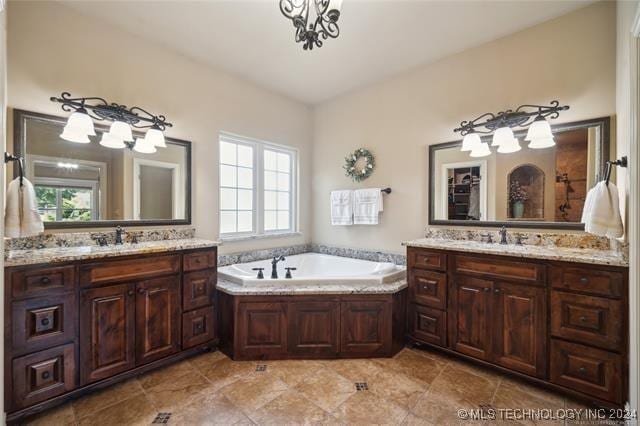 bathroom with a tub and vanity