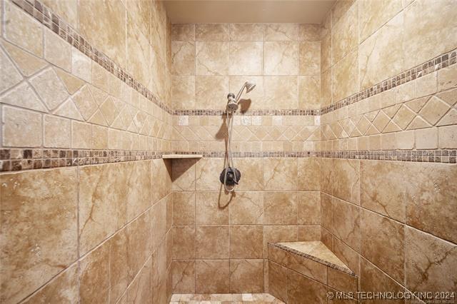 bathroom with a tile shower