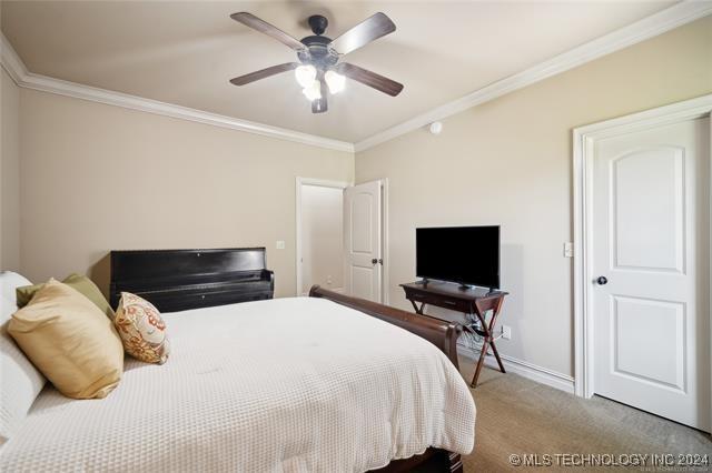 bedroom featuring carpet flooring, ceiling fan, and crown molding