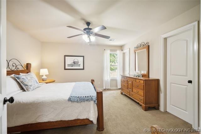 bedroom featuring ceiling fan and light colored carpet