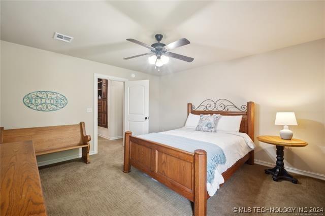 carpeted bedroom featuring a closet, a spacious closet, and ceiling fan