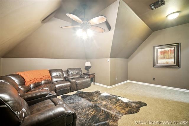 home theater featuring carpet floors, ceiling fan, and lofted ceiling