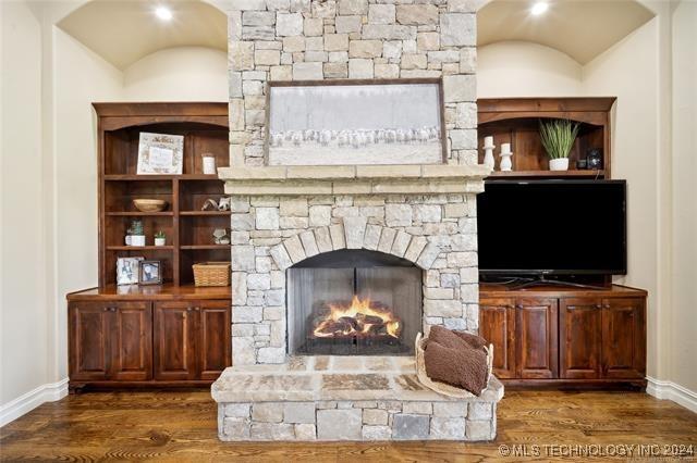 living room featuring dark hardwood / wood-style flooring and a fireplace