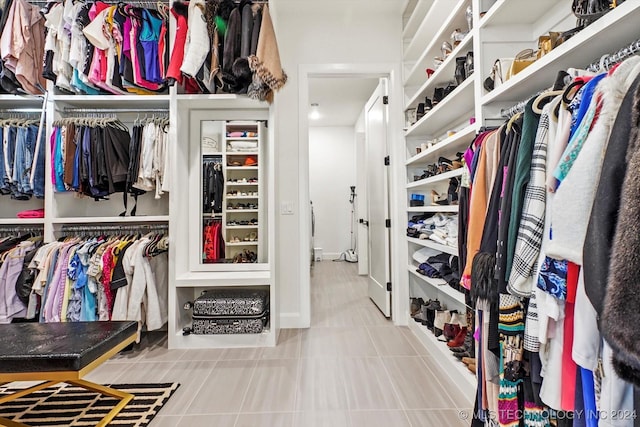 spacious closet with tile patterned floors