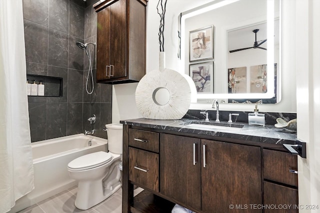 full bath featuring toilet, tile patterned floors, shower / bath combination with curtain, and vanity