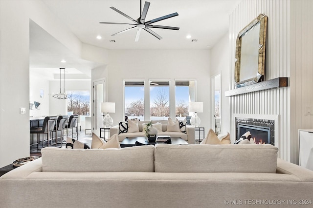 living room featuring recessed lighting, plenty of natural light, ceiling fan, and a glass covered fireplace